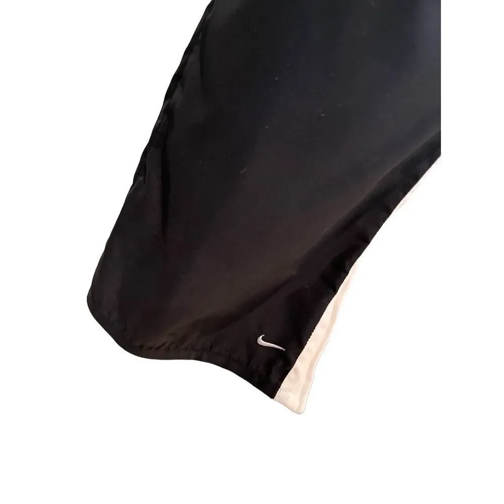 Nike black track pants with white side stripes and ankle zippers - L